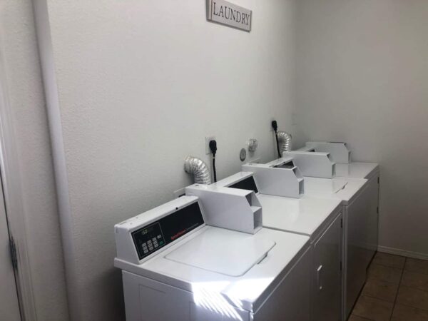 Alamo Studio Dwelling E laundry room with three machines