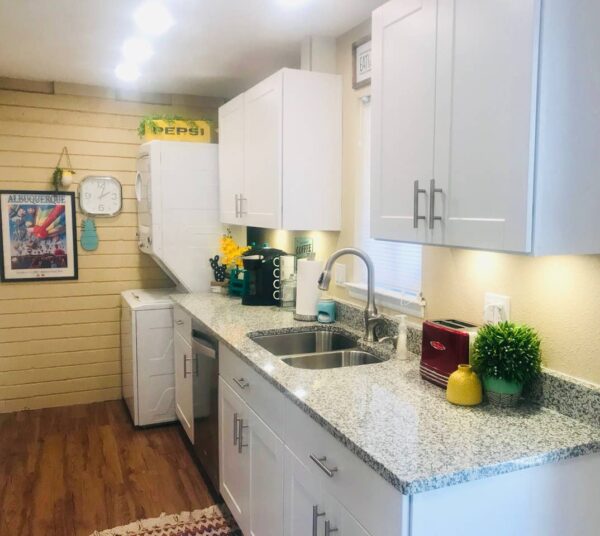 vintage dwelling combined kitchen and washer dryer with marble counter tops