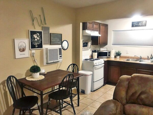 Alamo Apartment D dark wood kitchen with dark wood dining table and tile floor