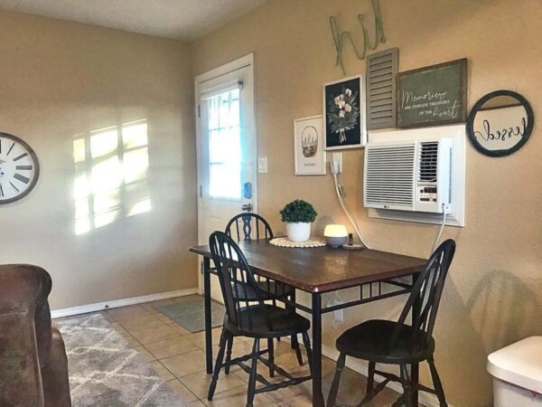 Alamo Apartment D dining area with wall unit and accent pieces