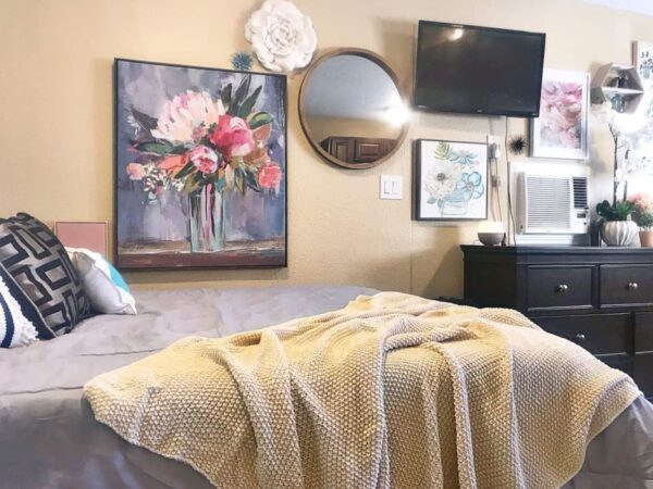 Alamo Studio Dwelling F bedroom with large flower print and mirror